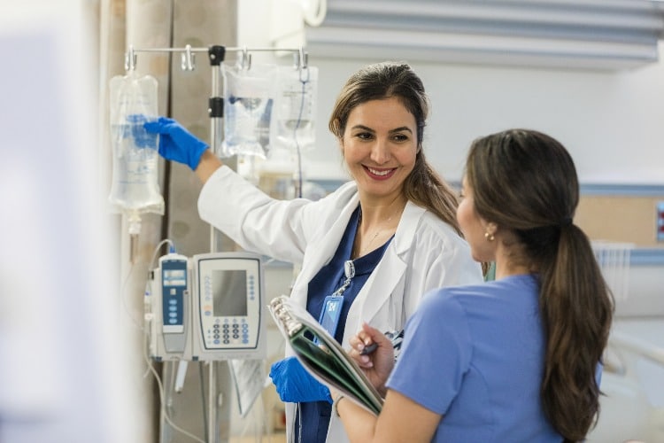Nurse administering IV infusion therapy to a resident