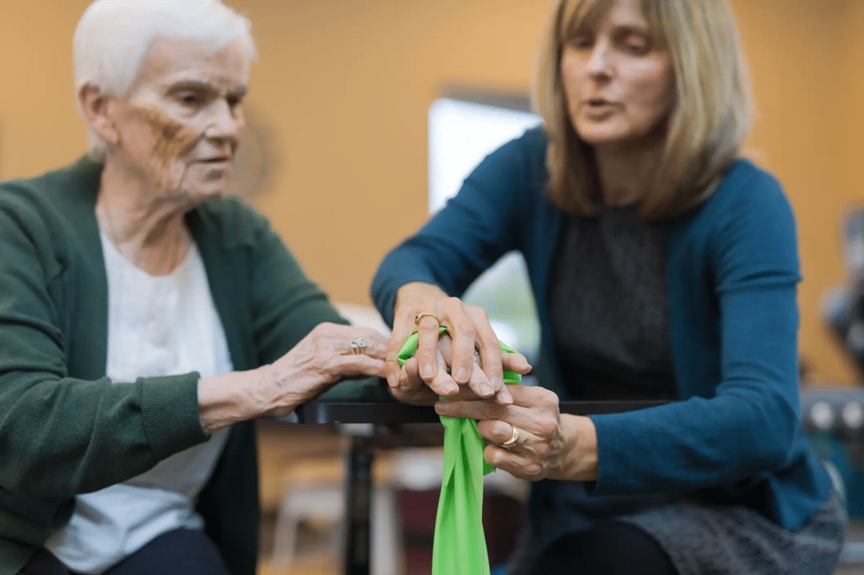 Occupational therapist helping a senior patient regain daily living skills