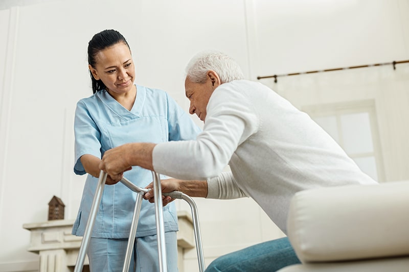 Skilled nursing team supporting an elderly resident