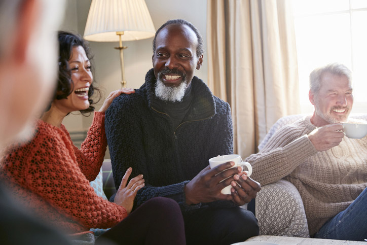 A senior man laughs with friends at a skilled nursing & rehab facility in Shreveport, LA