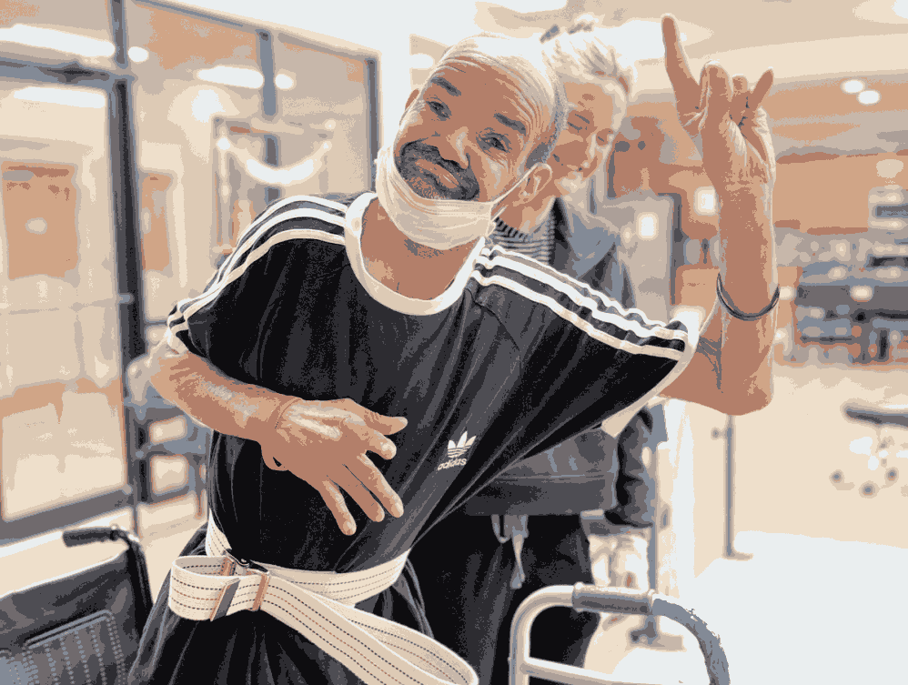 A man in a wheelchair with a bandage on his face, sitting outdoors in Shreveport, LA
