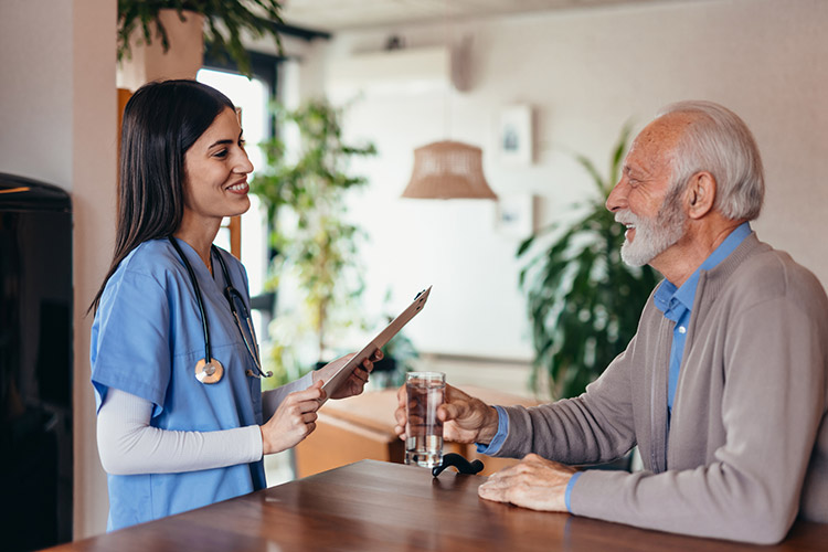A speech therapist in Shreveport helps a senior man with a swallowing disorder