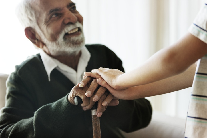 Elderly man and young girl hold hands, symbolizing connection in hospice care, Shreveport, LA